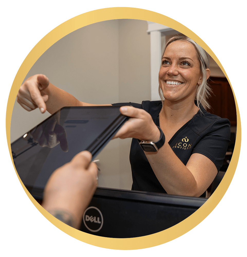 Team member handing tablet to Patient