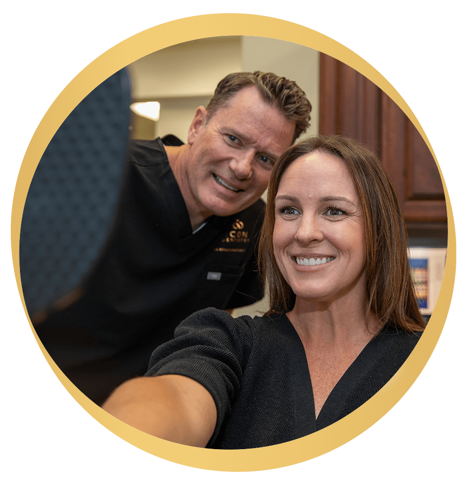 Patient and team member smiling into mirror