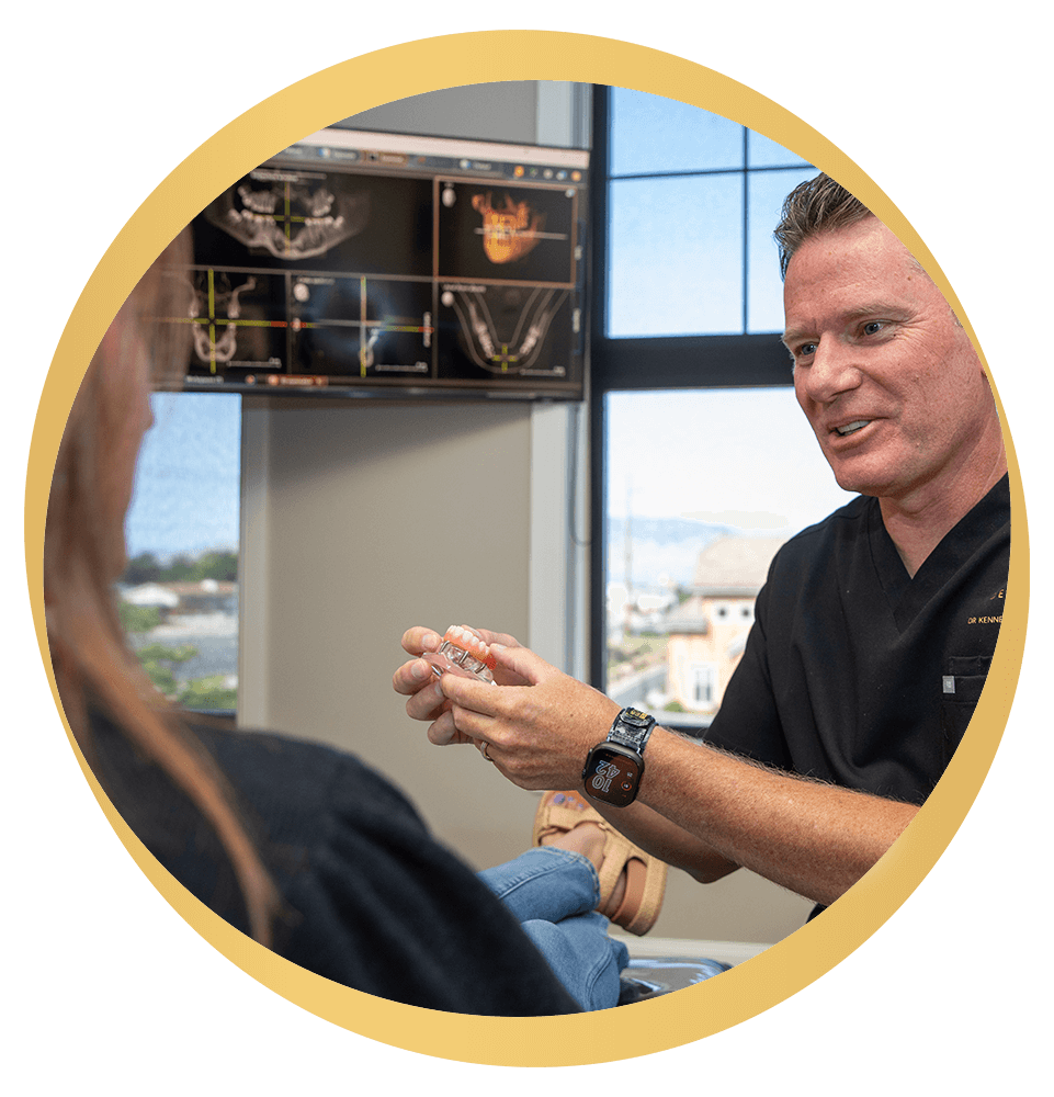 Doctor Holding up model of full arch